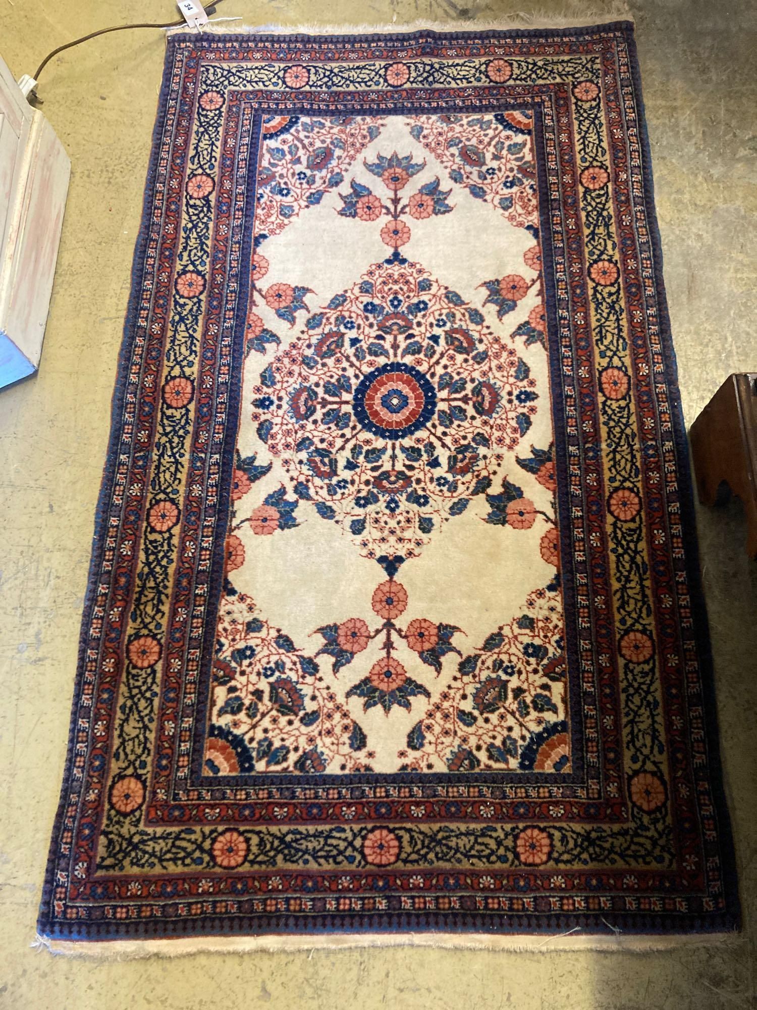 A North West Persian cream ground rug, 133 x 76cm
